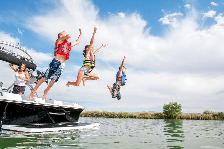 Family with Watercraft Boat Insurance Jumping into a Tega City, SC Lake