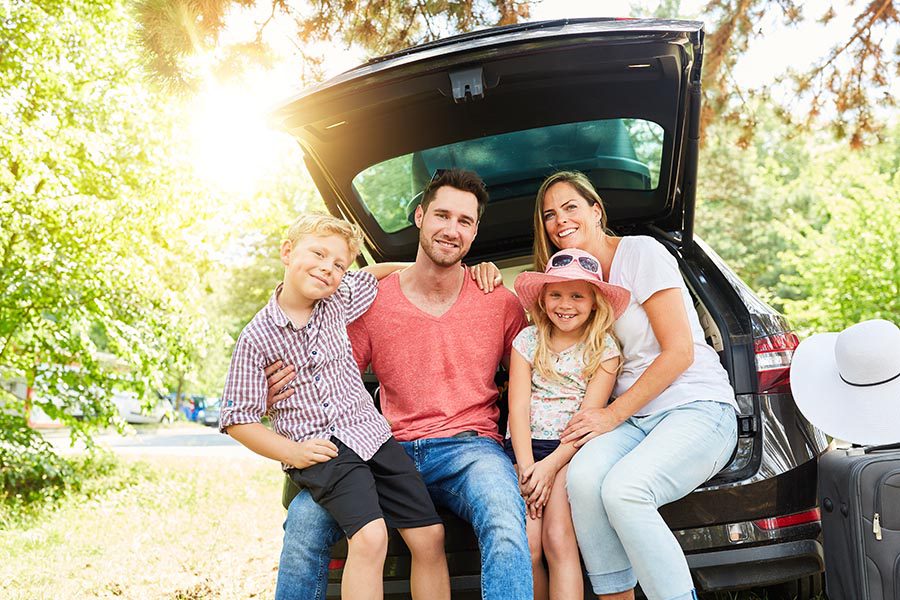 Family Sitting on Truck of Car with Car Insurance in Belmont, Charlotte, Columbia, Gastonia, Rock Hill, Shelby, NC